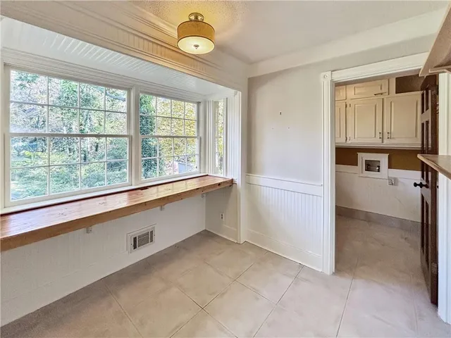 a view of a kitchen with a sink and dishwasher cabinets