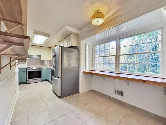 a kitchen with refrigerator and microwave