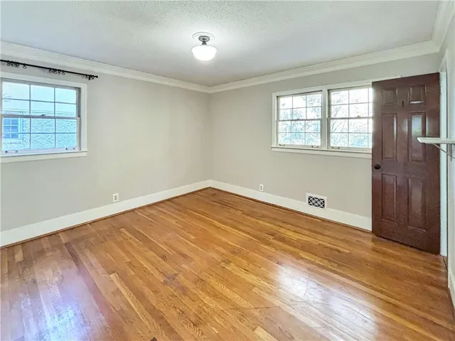 a view of a room with wooden floor and windows