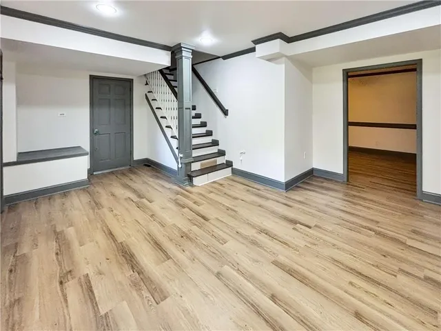 a view of an empty room with stairs and ventilation