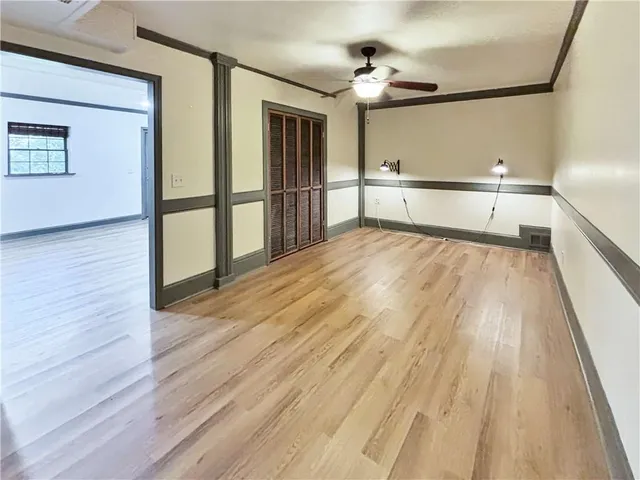 a view of a room with wooden floor and staircase