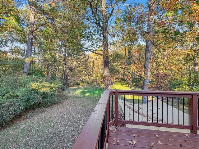 a view of balcony with wooden floor and fence