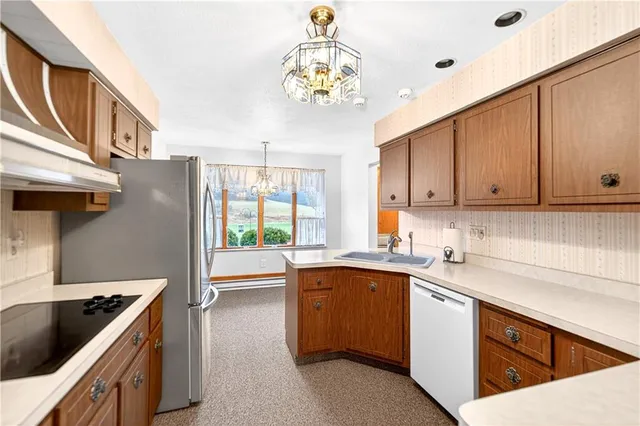 a view of an empty room with a fireplace and a window