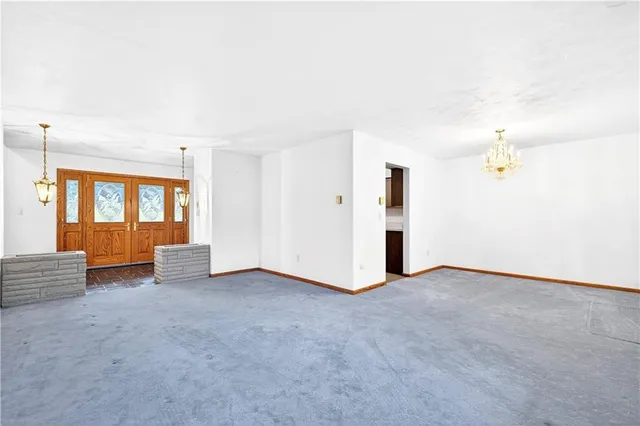 a view of a yard in front of a house with large tree