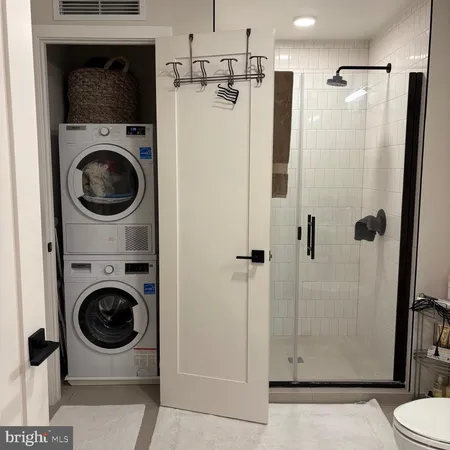 a bedroom with a bed a mirror and lamp