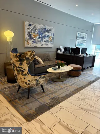 a living room with furniture and wall painting