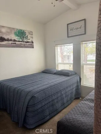a bedroom with a bed and a painting
