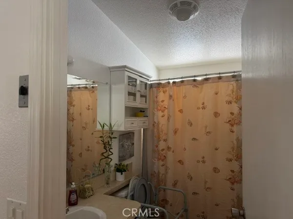 a view of a hallway with wooden floor and entryway