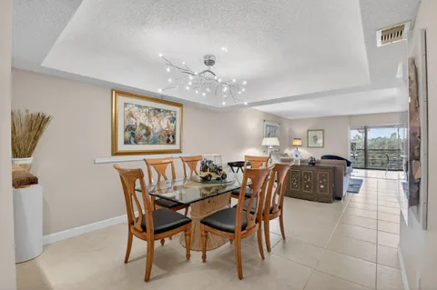 a dining room with furniture and a chandelier