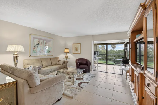 a living room with furniture and a floor to ceiling window