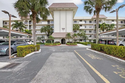 a view of building with cars parked