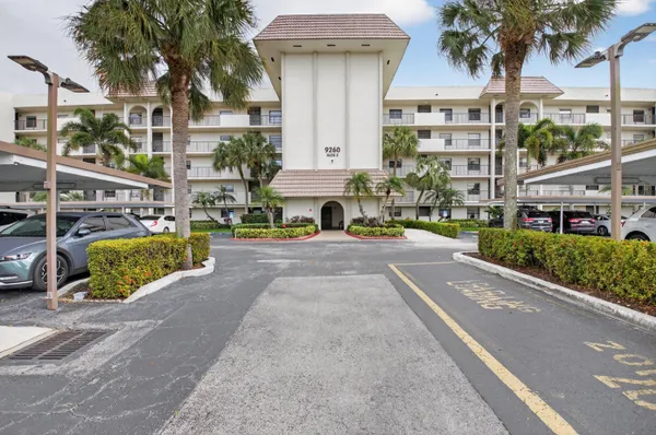 a view of building with cars parked