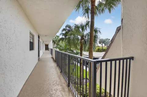 a view of a balcony with palm trees