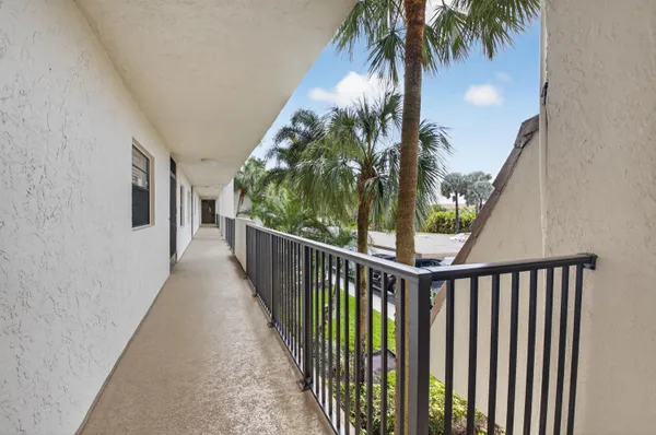 a view of a balcony with palm trees
