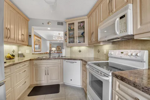 a kitchen with cabinets appliances and a counter top
