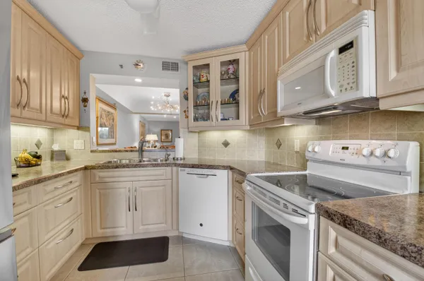 a kitchen with cabinets appliances and a counter top