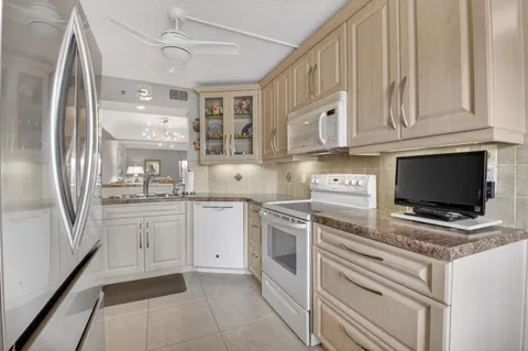 a kitchen with cabinets appliances and a sink