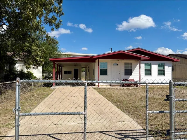 a view of a house with swimming pool and sitting area