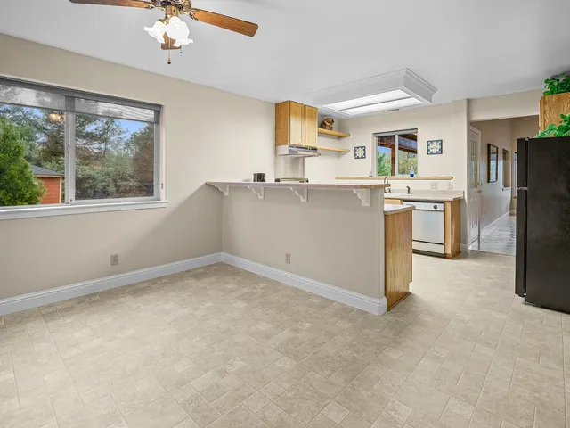 a view of kitchen with furniture and refrigerator