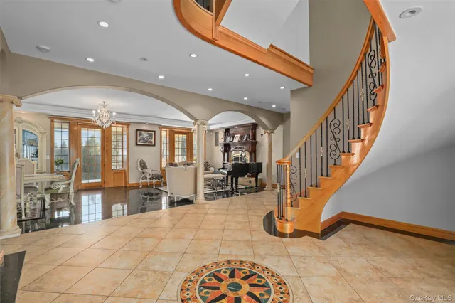 a view of an entryway with wooden floor and a livingroom view