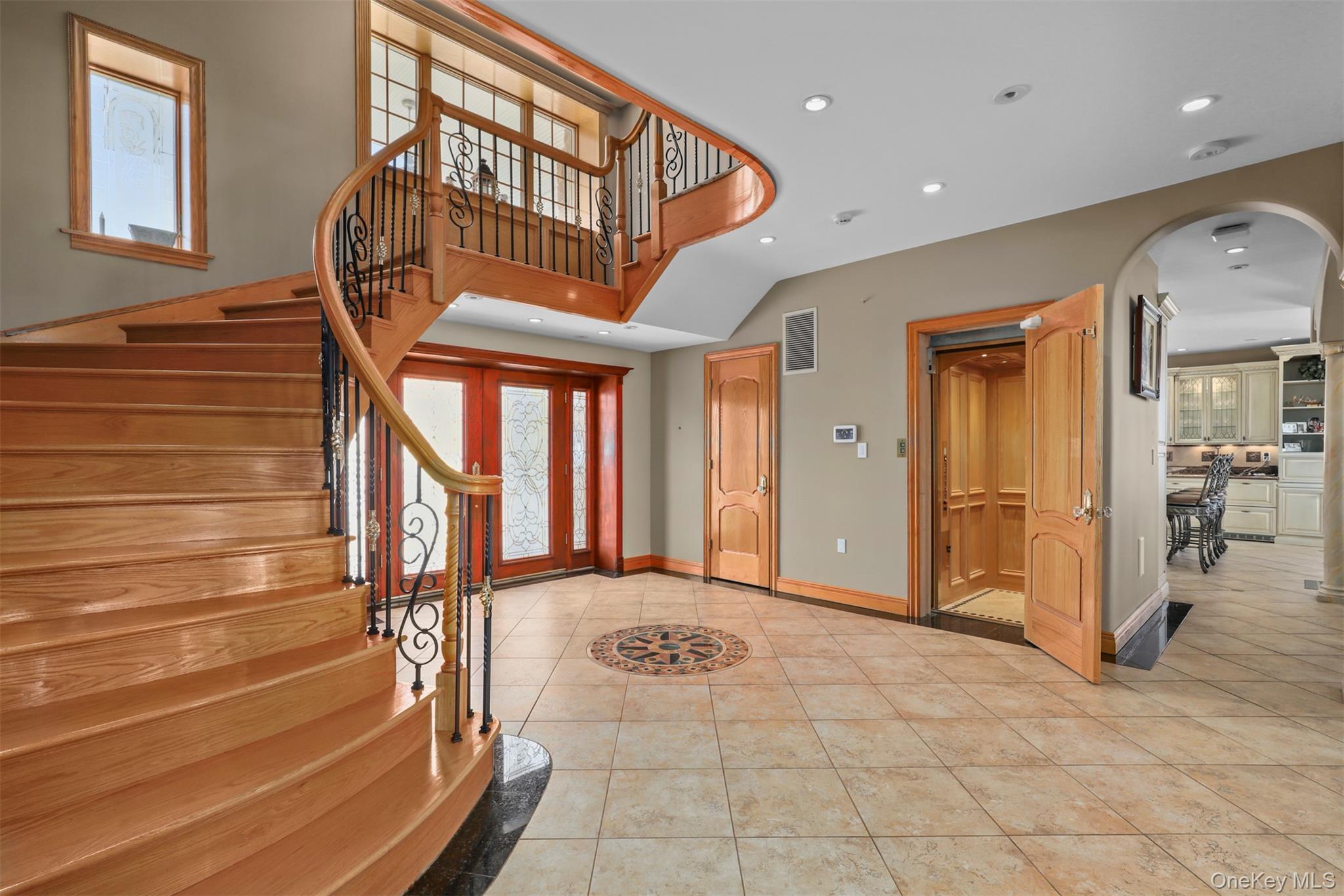 3407 Country Club Road Bronx, NY 10465 - Photo 14 of 34 Foyer entrance with visible vents, arched walkways, stairs, and tile patterned flooring