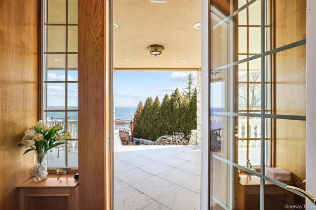 a kitchen with stainless steel appliances a dining table chairs sink and cabinets