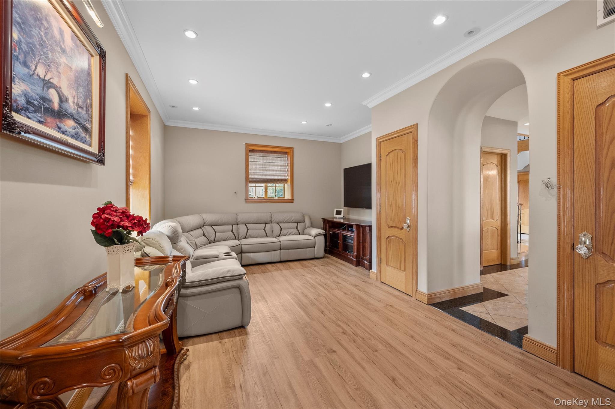 3407 Country Club Road Bronx, NY 10465 - Photo 19 of 34 Living room with visible vents, ornamental molding, light wood-style flooring, recessed lighting, and arched walkways