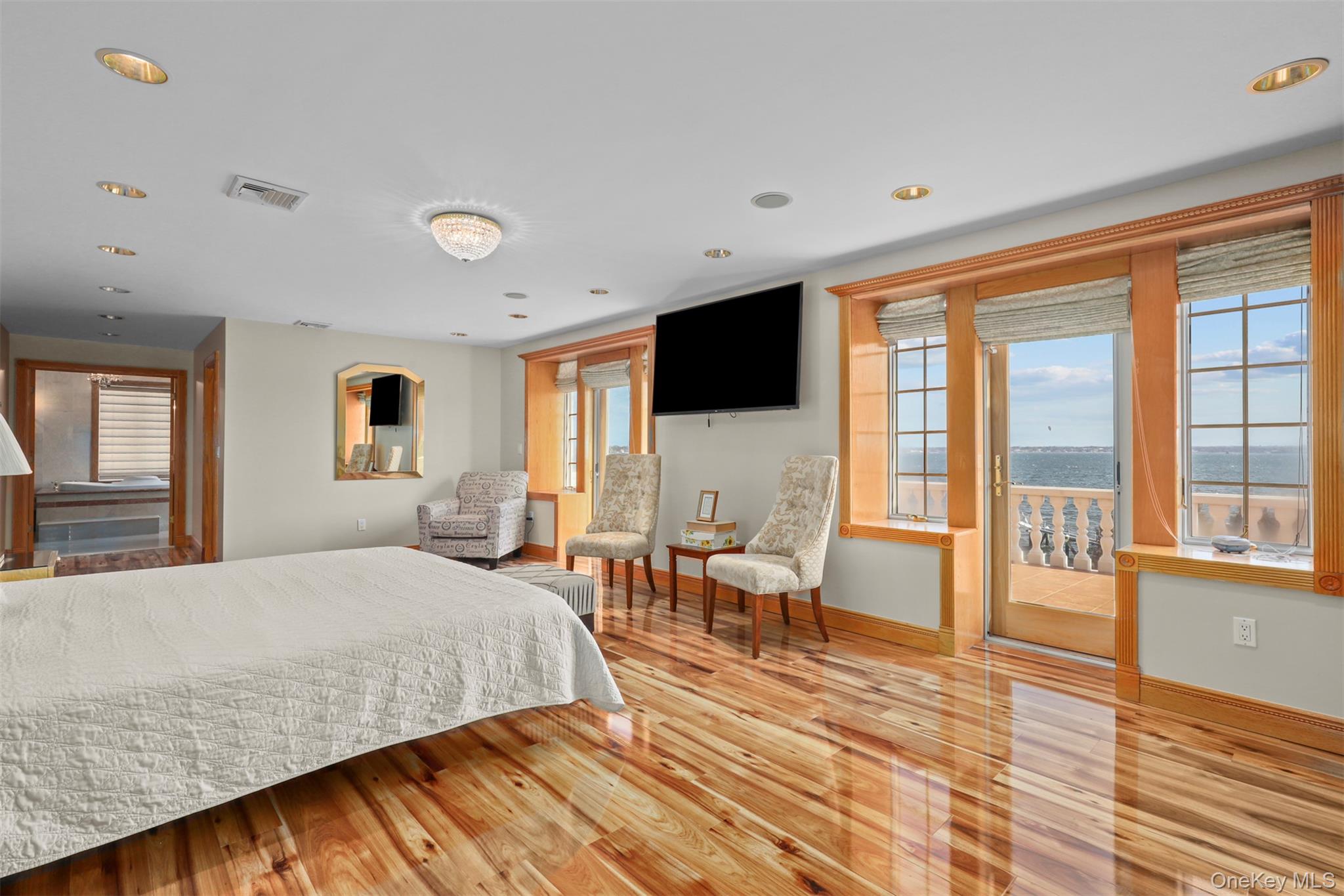 3407 Country Club Road Bronx, NY 10465 - Photo 23 of 34 Bedroom featuring visible vents, multiple windows, baseboards, and wood finished floors