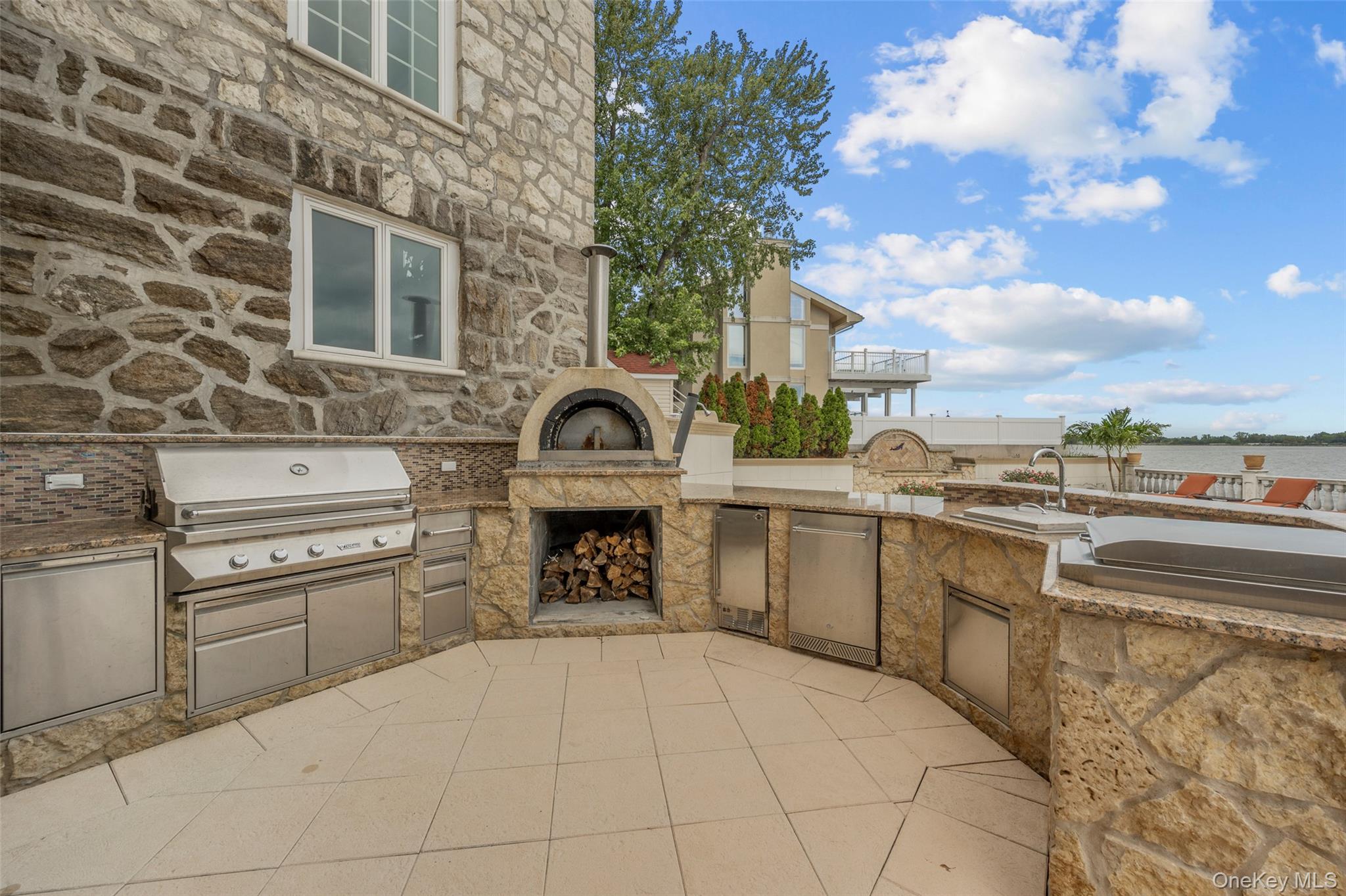 3407 Country Club Road Bronx, NY 10465 - Photo 10 of 34 View of patio with exterior fireplace, area for grilling, and exterior kitchen