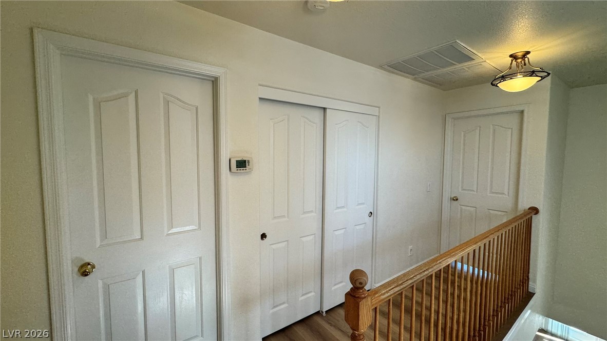 9716 Ridge Creek Place Las Vegas, NV 89134 - Photo 14 of 28 This interior hallway features classic doors and durable flooring, offering both privacy and enduring appeal.