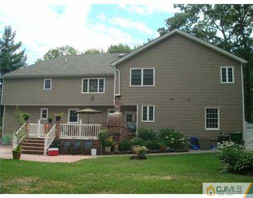 19 Frances Road Edison, NJ 08820 - Photo 4 of 6 a front view of a house with a garden and plants