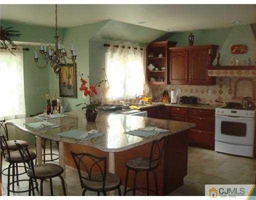 19 Frances Road Edison, NJ 08820 - Photo 5 of 6 a kitchen with a sink cabinets and wooden floor