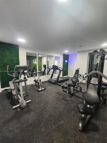 a room with gym equipment and windows