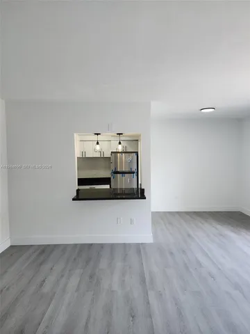a kitchen with kitchen island granite countertop a sink and a stove