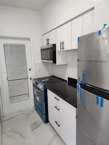 a close view of a sink a counter and cabinets