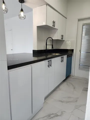 a utility room with sink dryer and washer