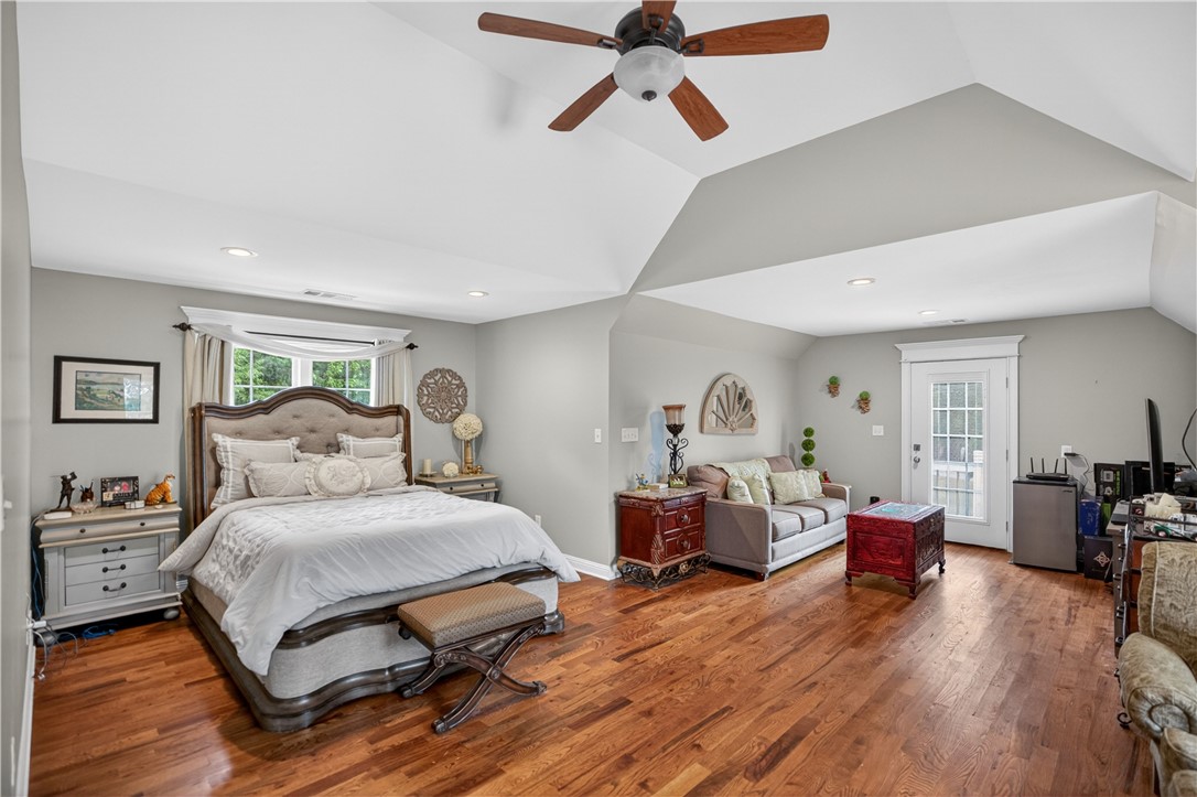 206 James Hare Road Anderson, SC 29626 - Photo 28 of 37 Hardwood floors and vaulted ceilings create an inviting and spacious bedroom retreat with private outdoor access.