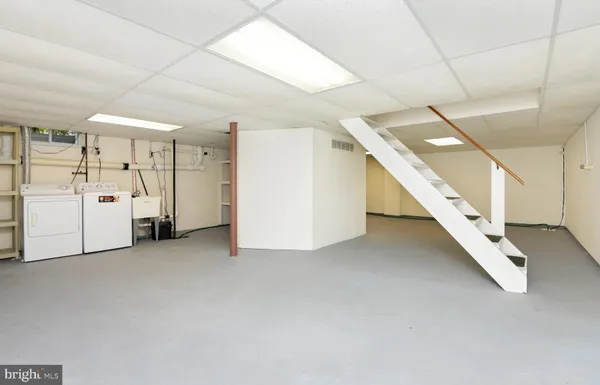 an empty room with a white walls and stairs