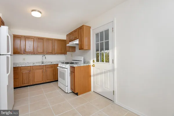 a kitchen with a stove a sink and a refrigerator