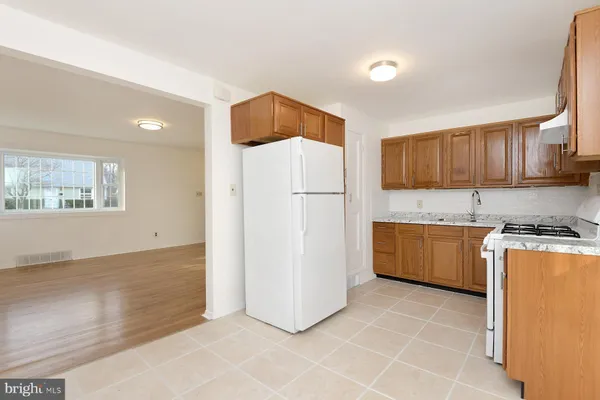 a kitchen with stainless steel appliances a refrigerator sink and stove