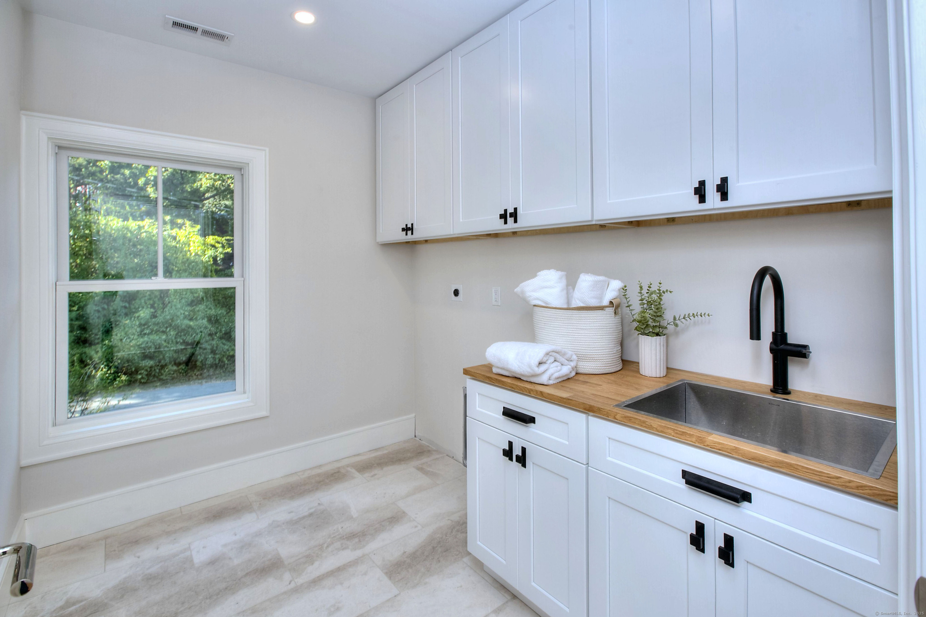 3 Hickory Hill Road Westport, CT 06880 - Photo 18 of 34 a kitchen with stainless steel appliances a sink a stove and white cabinets with wooden floor