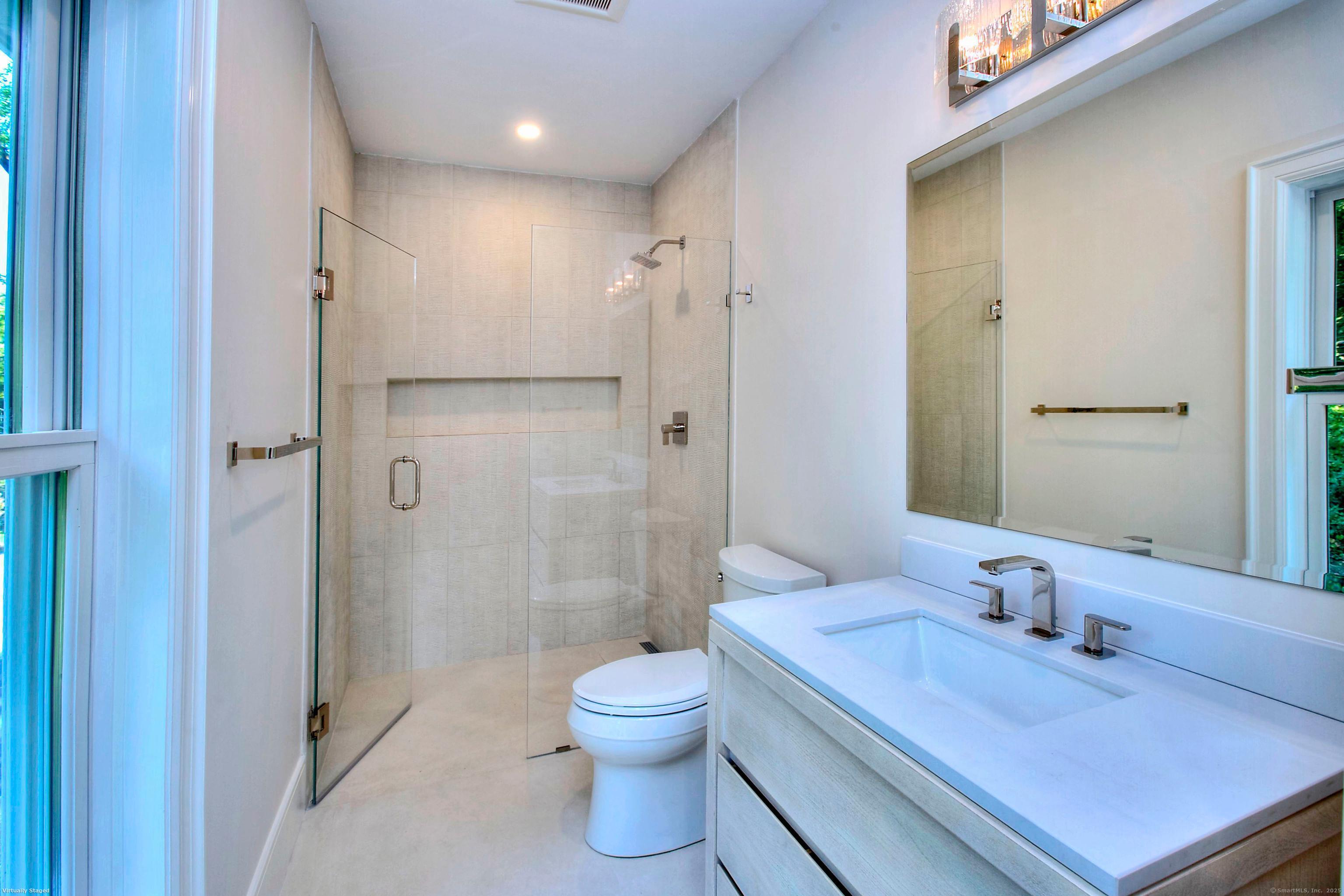 3 Hickory Hill Road Westport, CT 06880 - Photo 24 of 34 a bathroom with a granite countertop sink a toilet a mirror and shower