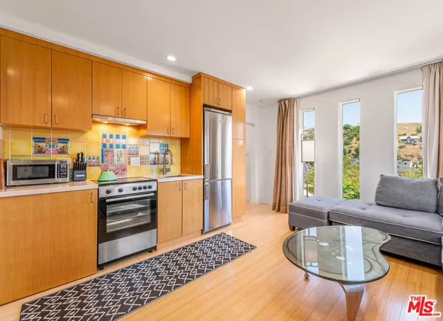 a kitchen with stainless steel appliances granite countertop a refrigerator and cabinets