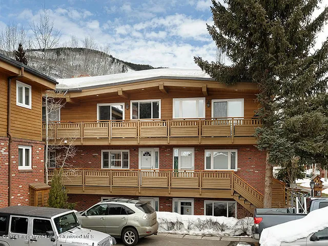 a front view of a building with parking space