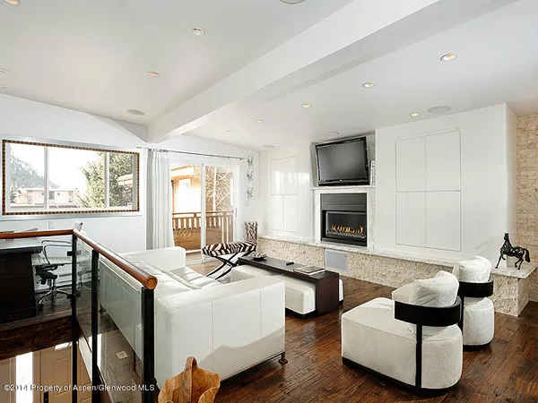 a living room with furniture and flat screen tv