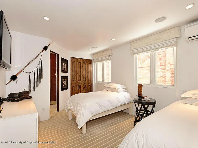 a bedroom with a bed couch and a window