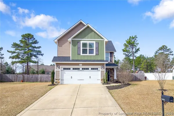a front view of a house with a yard and garage