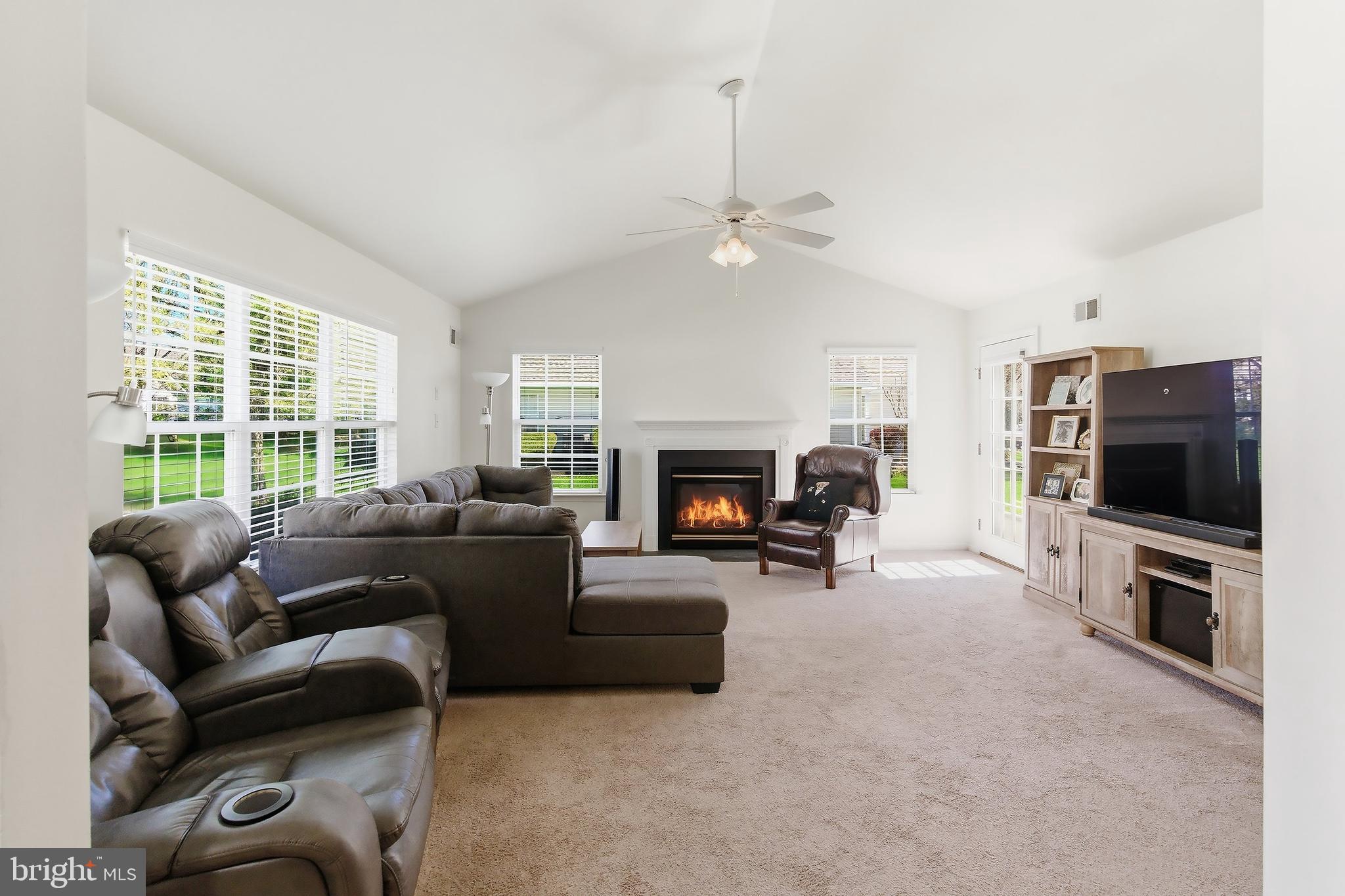 7 Ivy Hill Road Lakewood, NJ 08701 - Photo 14 of 51 a living room with furniture a fireplace and a flat screen tv