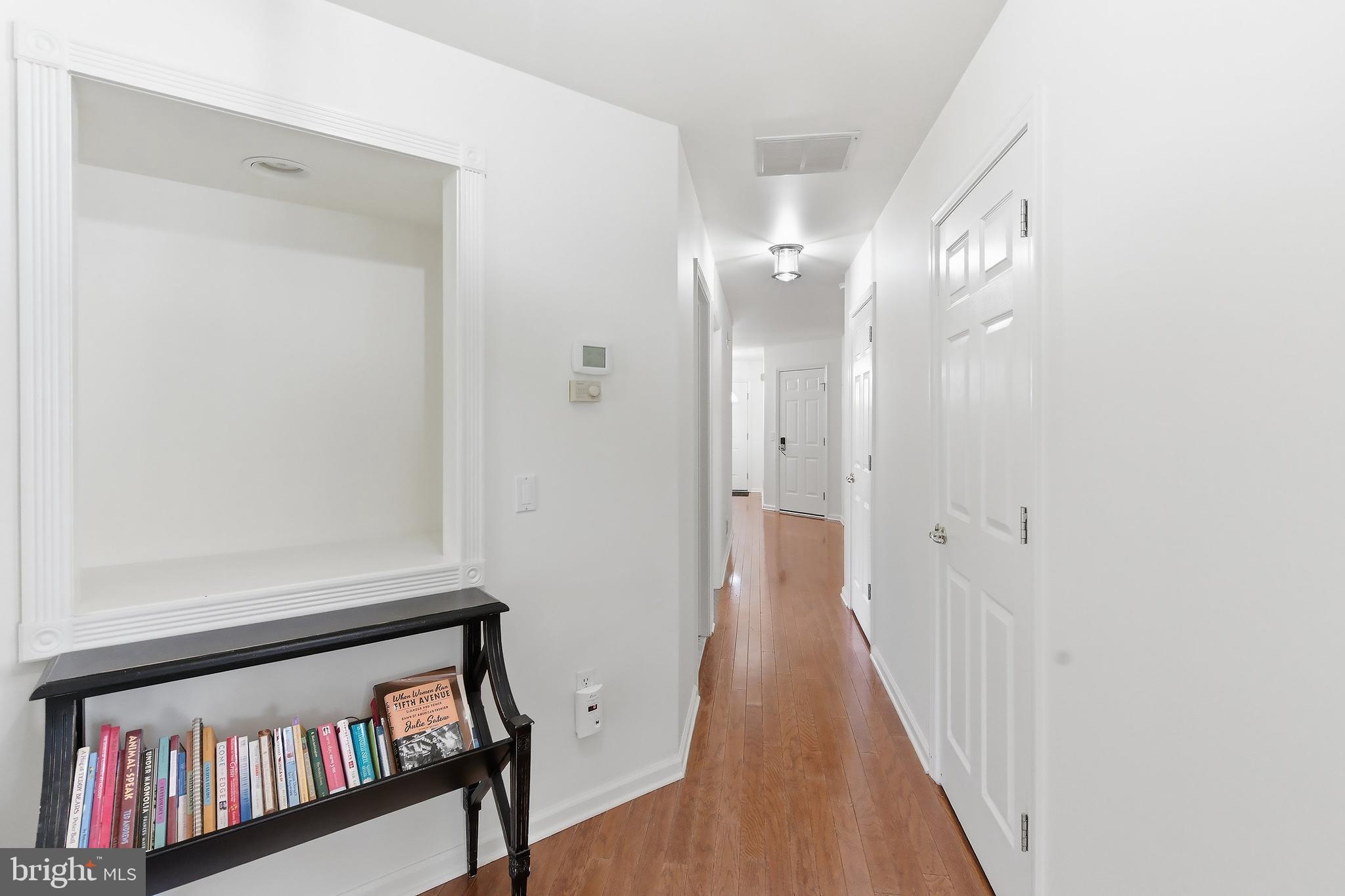 7 Ivy Hill Road Lakewood, NJ 08701 - Photo 9 of 51 a view of a hallway with wooden floor and door in a room