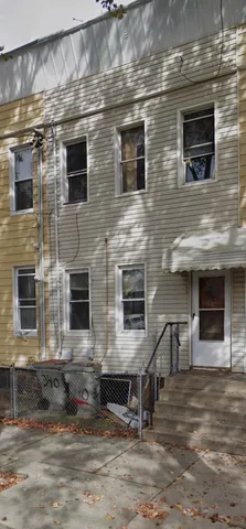 a view of a brick house with many windows